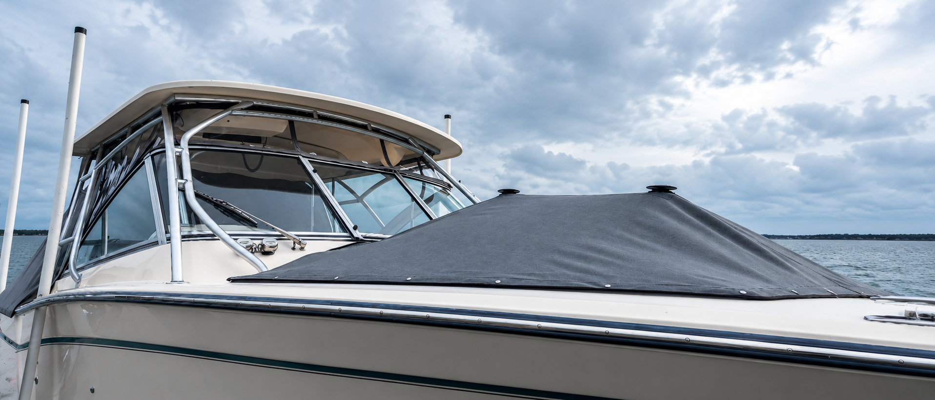 Custom-fitted gray boat bow cover and clear marine enclosure by Tangi's Custom Creations in Tarpon Springs, FL