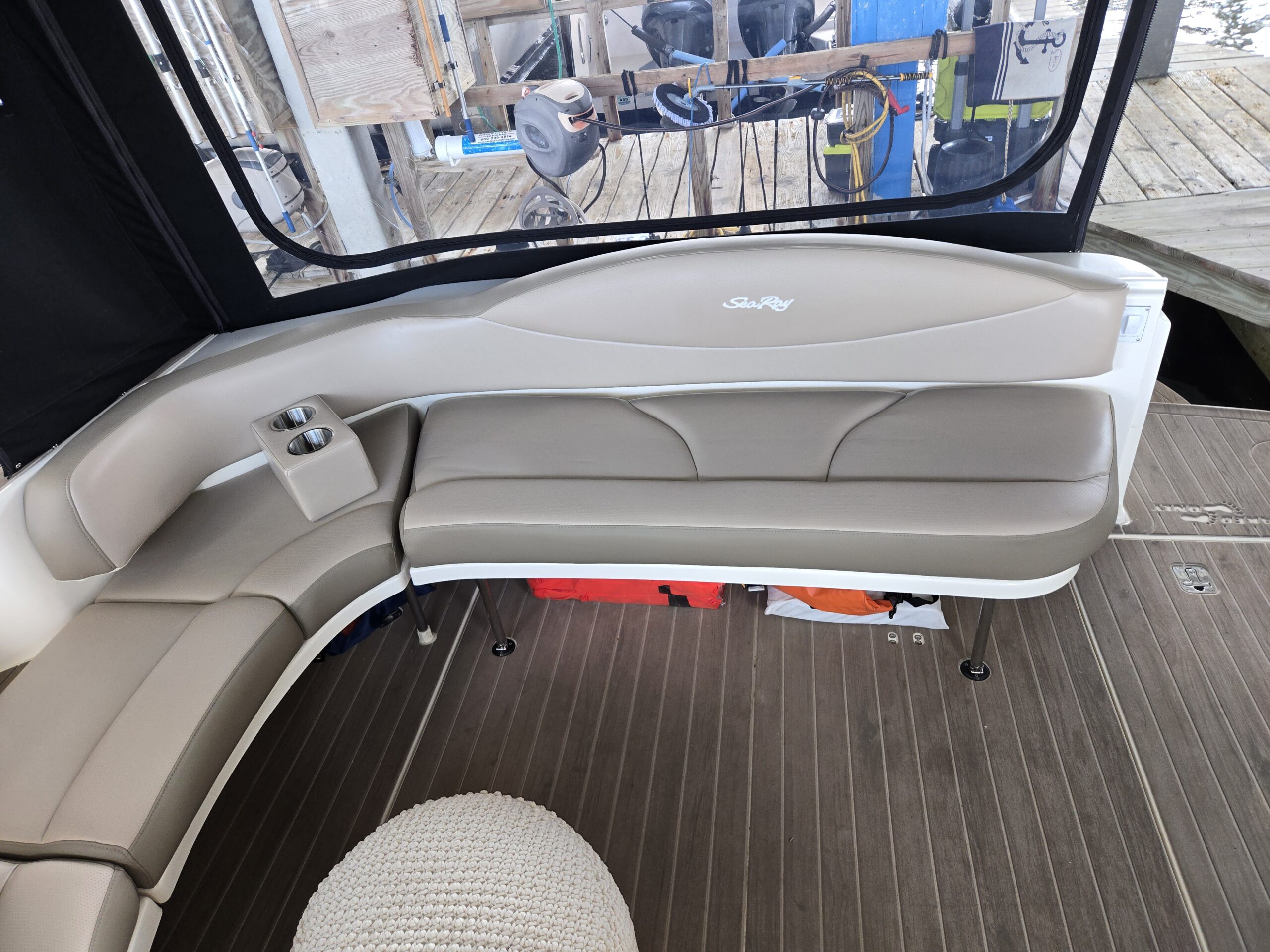 Installed cream and taupe marine cockpit seating with shaped backrests by Tangi’s Custom Creations.